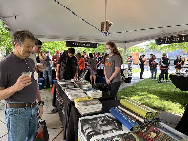 Shoppers peruse books at the Princeton Art Museum tent.