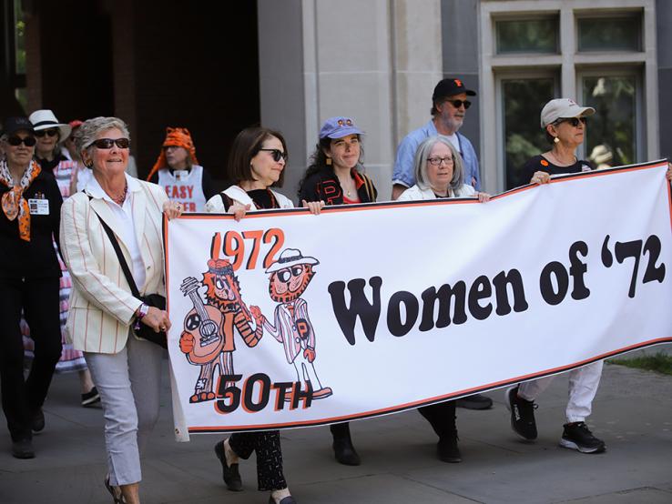 Women carry a "Women of ’72" banner in the P-rade.