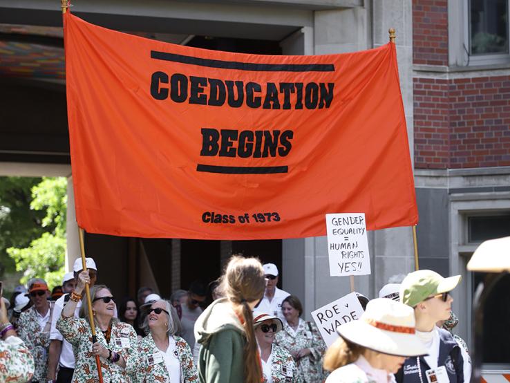 The orange "Coeducation Begins: Class of 1973" banner in the P-rade.