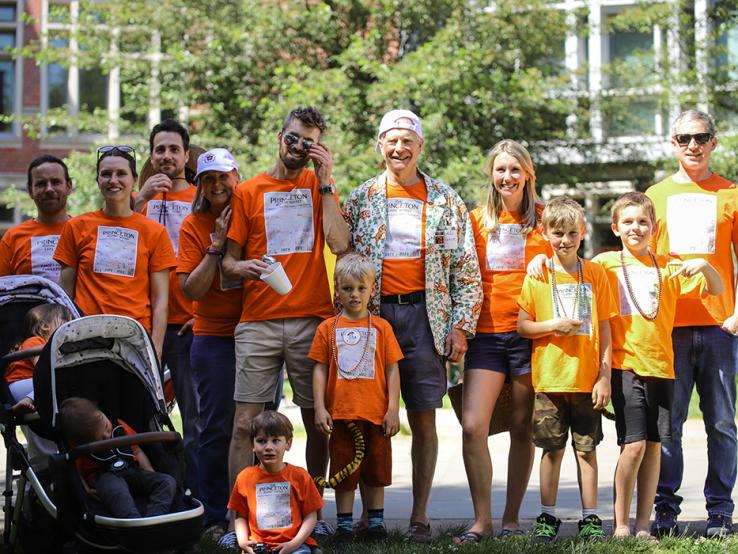 A family wears matching orange shirts in the P-rade.
