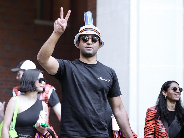 A guy flashes the peace sign.
