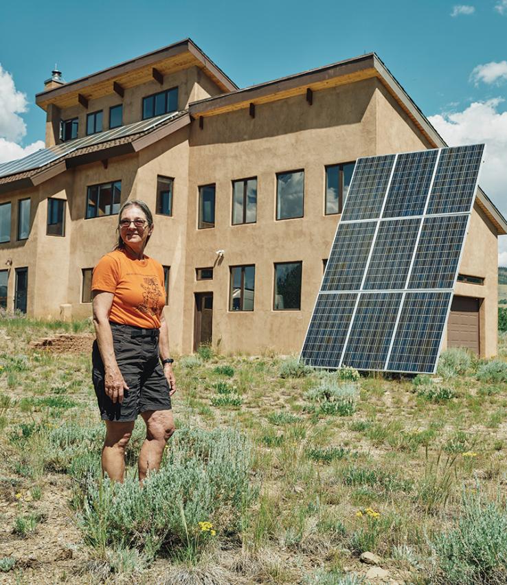 Anne Brenner in front of her solar powered home.