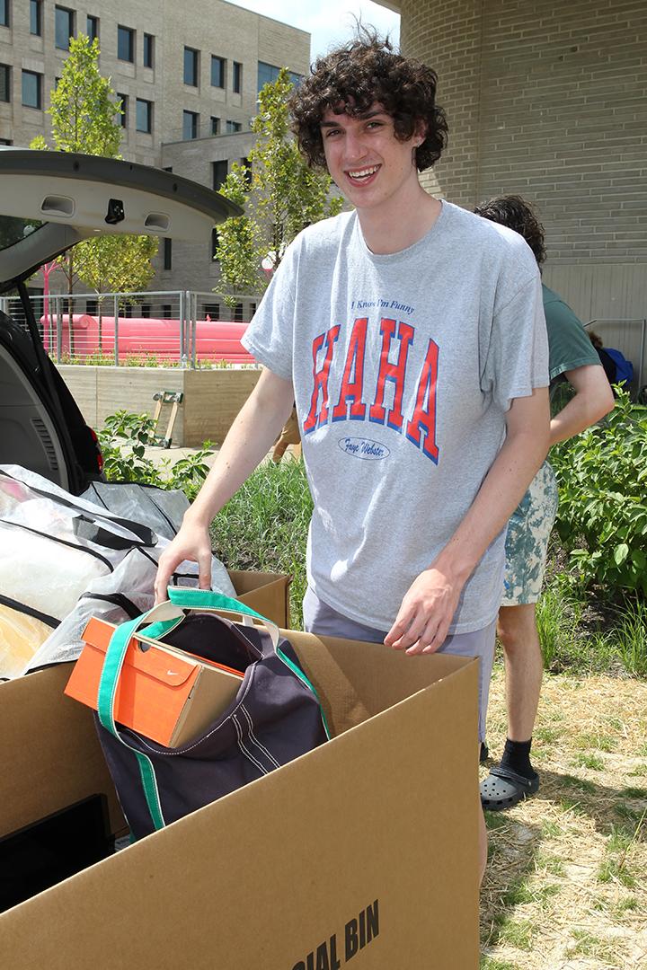 Harry Gorman ’26 stands with the boxes he's moving into Princeton.