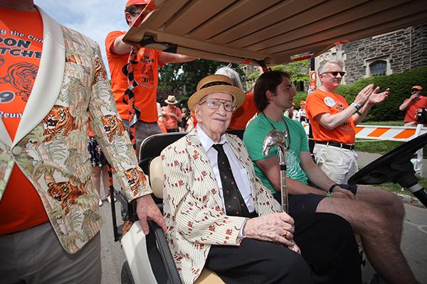 Don Fletcher ’30 *51 holds the silver Class of 1923 Cane while riding in a golf cart at the P-rade. 