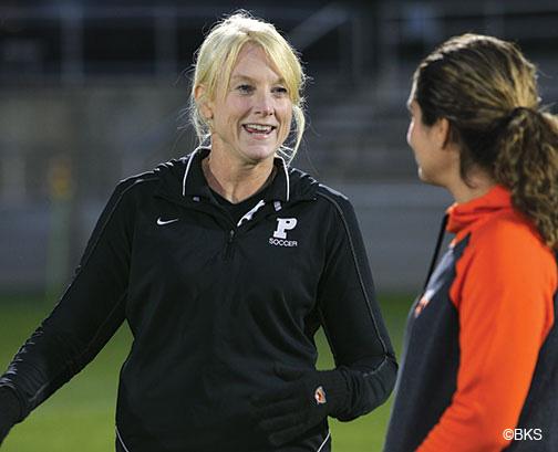 Julie Shackford, left, talks with assistant coach Esmeralda Negron ’05 before the Tigers’ Oct. 11 win over Brown.