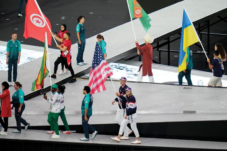 Gold-medal winning rower Nick Mead ’17, bottom, and swimming star Katie Ledecky are the flag bearers for the United States in the closing ceremony of the Paris Olympics. 