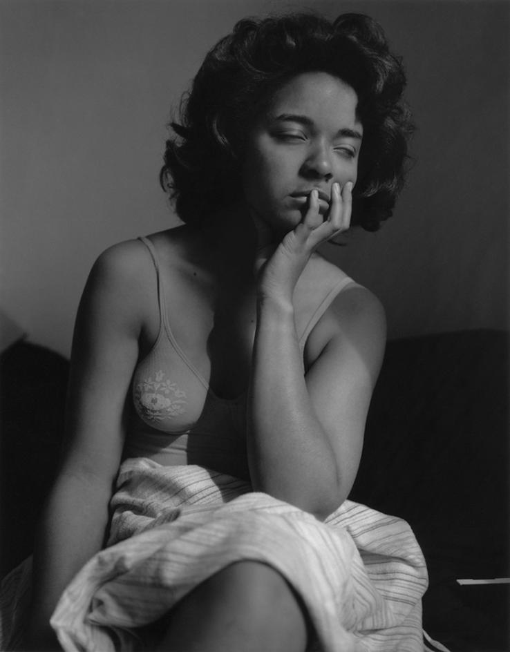 In this black-and-white photo, Carla Williams closes her eyes and rests her chin in her left hand.