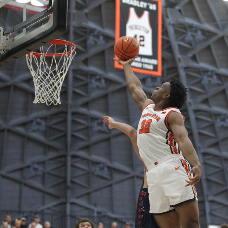 Princeton's Keeshawn Kellman stretches high to grab a rebound