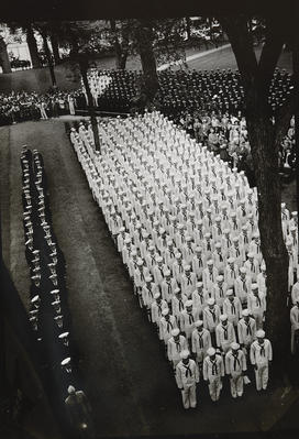 In this sepia-toned photograph, sailors march in lines.