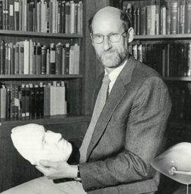 Man holding a plaster cast of a face