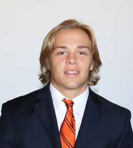 Tiger Bech in suit with orange tie