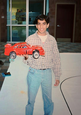 Student holding an electric car in the 1990s