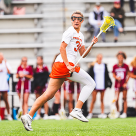 Lacrosse attacker McKenzie Blake runs while cradling the ball in her stick