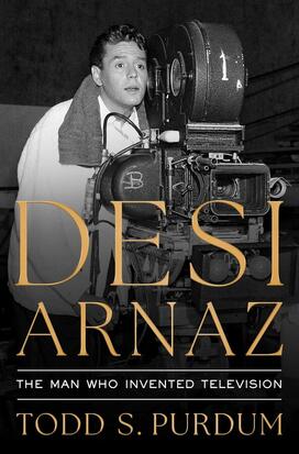 The cover of Todd Purdum's book "Desi Arnaz," featuring a photo of Arnaz looking out from behind an old fashioned TV camera.