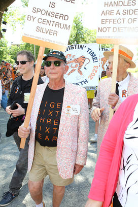 Members of the Class of 1963 hold signs as they march in the 2023 P-rade