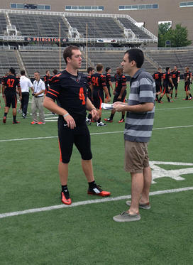 Quinn Epperly ’15, left, sports the Tigers’ new jersey at football media day.