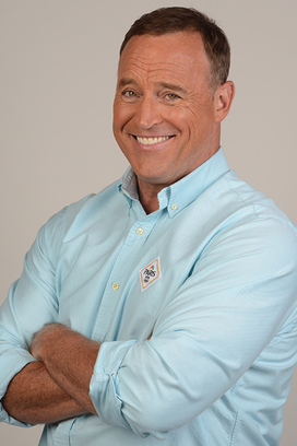 Matt Iseman headshot, smiling with arms folded