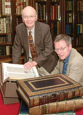 pres_10.jpg In this 2002 photo, William H. Scheide ’36 (standing) and Scheide Librarian Paul Needham look over some of the first printed editions of the Bible, which are part of the magnificent collection of rare books and manuscripts that now have a permanent home