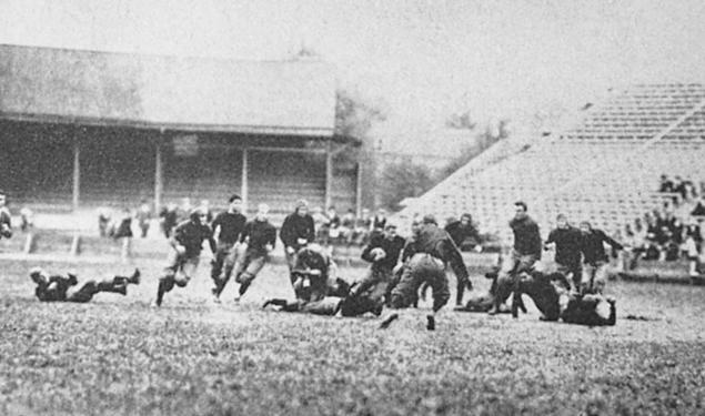 Black and white photo of Hobey Baker and his team on the field playing football.