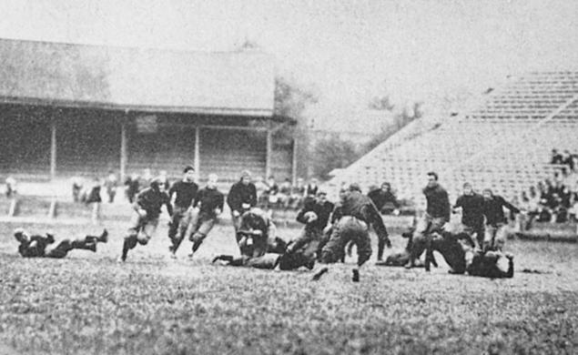 Black and white photo of Hobey Baker and his team on the field playing football.