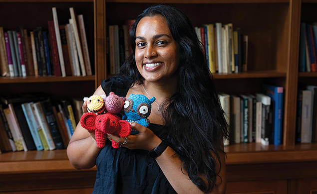Julianne Somar ’26 shows off some of the nontraditional items in the emergency go-bag the team designed.