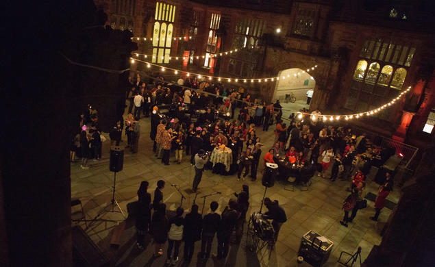 People gather under fairy lights strung across the East Pyne courtyard.
