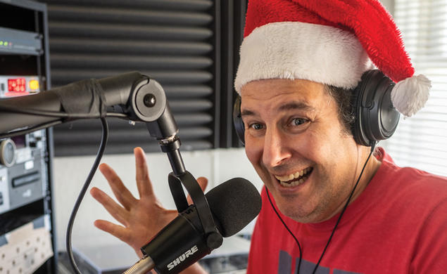 Jon Solomon in Santa Claus hat behind the mic int he WPRB studio