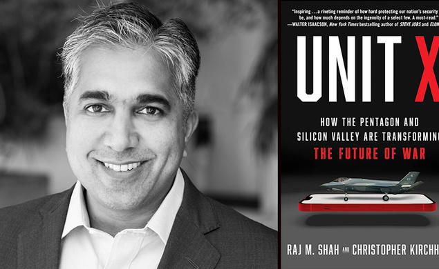 Raj Shah with the cover of his book, "Unit X," featuring an image of a fighter jet on top of a cell phone.