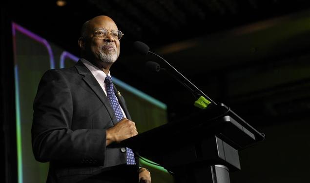 Rep. Glenn Ivey stand at a podium during election night. 