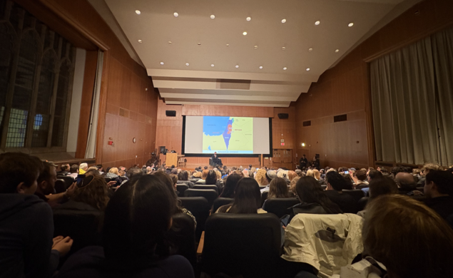 Mosab Hassan Yousef sits in front of a crowd in McCosh 10.