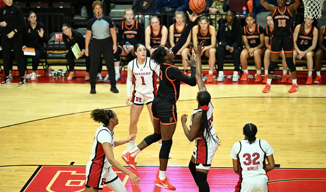 A Princeton basketball player launches the ball toward the basket from the paint.