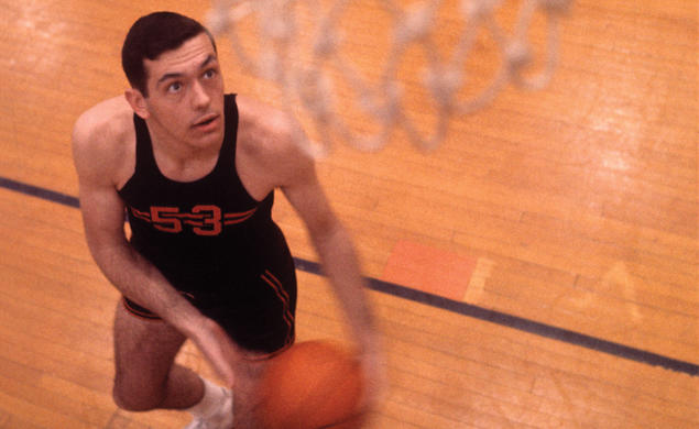 Bill Bradley ’65 looks up at the basketball net hanging in the foreground.
