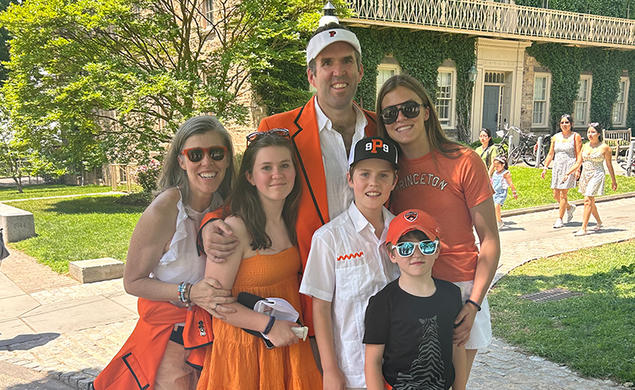 Two parents and their four children, dressed in orange for Princeton Reunions.