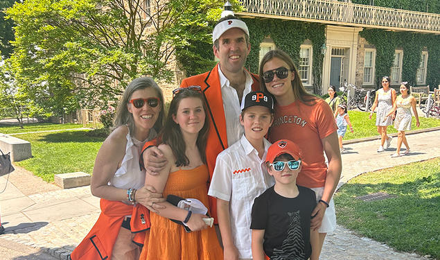 Two parents and their four children, dressed in orange for Princeton Reunions.