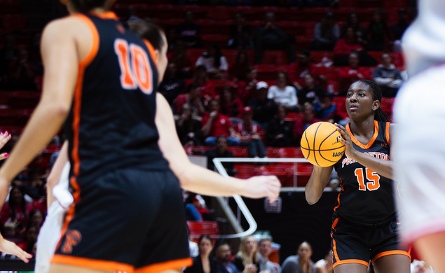 Fadima Tall ’27, a basketball player in a black Princeton uniform, sets up a shot.