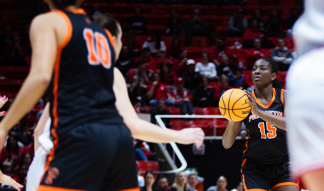 Fadima Tall ’27, a basketball player in a black Princeton uniform, sets up a shot.