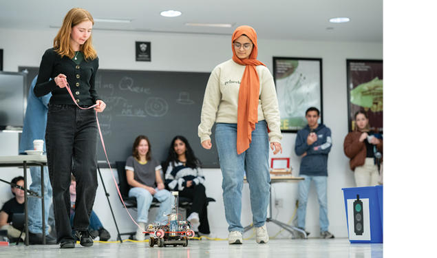 Caroline Rasmussen ’26, left, and Yushra Guffer ’26 present their Car Lab vehicle at the end of the semester,  a tradition that began in  the 1990s