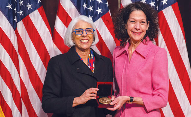 Professor Bonnie Bassler, right, receives  the National Medal of Science from  White House adviser Arati Prabhakar.