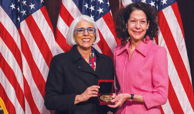 Professor Bonnie Bassler, right, receives  the National Medal of Science from  White House adviser Arati Prabhakar.