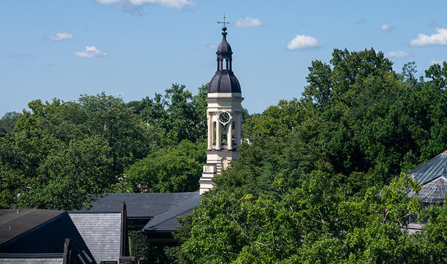 The cupola of Princeton's Nassau Hall peeks up from surrounding leafy trees.