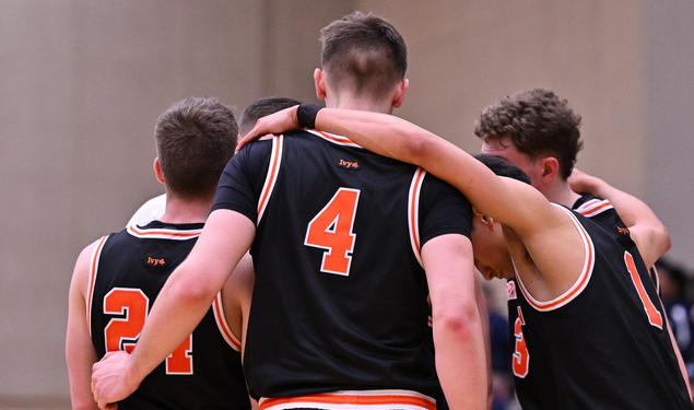 Princeton men’s basketball in a huddle.