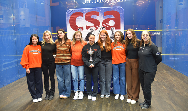 Members of the Princeton women's squash team posing on a squash court in New York City