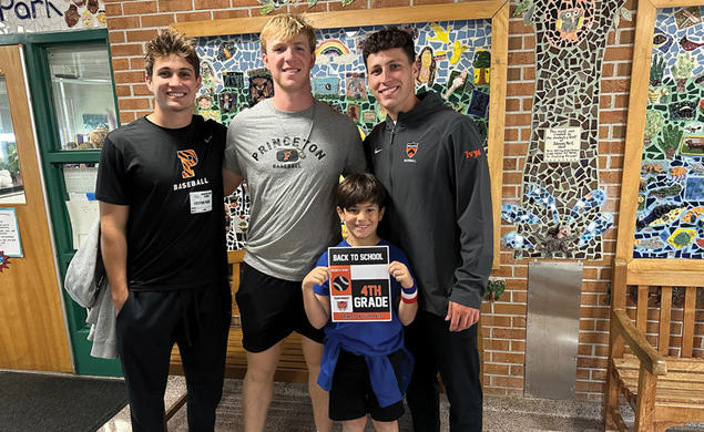 Baseball players, from left, Grant Werdesheim ’28, Jake Kernodle ’27, and Andrew D’Alessio ’25 catch up with a fourth-grader at Johnson Park Elementary.