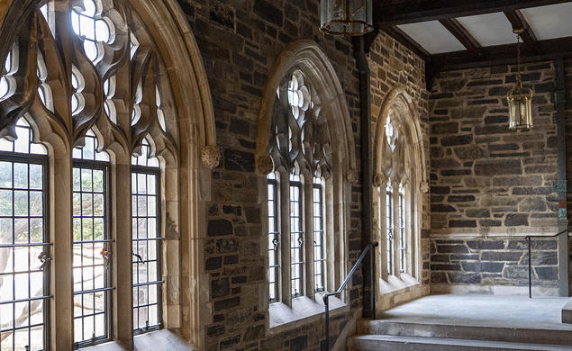 Gothic stone windows above a staircase in the Graduate College.