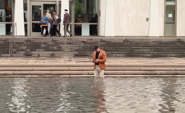 PAW writer Mark F. Bernstein '83 stands in the reflecting pool of the Fountain of Freedom