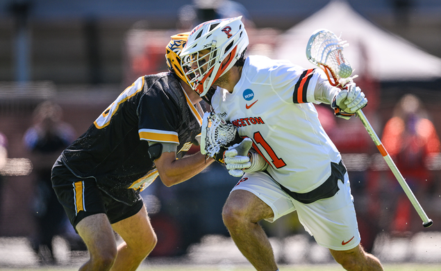 Coulter Mackesy cradles the ball in his stick as he tries to get past a defender