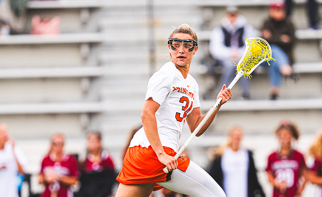 Lacrosse attacker McKenzie Blake runs while cradling the ball in her stick