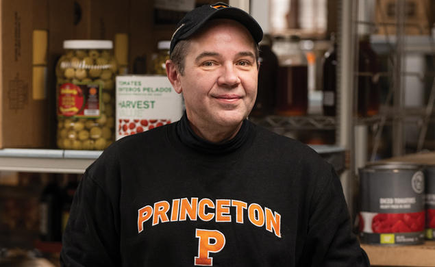 Damon Schunk, a senior storekeeper in Campus Dining, standing in a large food pantry