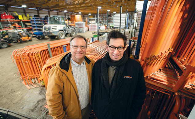 Devin Livi, director of campus grounds, left, and Robert Staudt, assistant director of campus grounds stand in the the storage area for much of the Reunions hardware such as fending, electrial wires, etc.