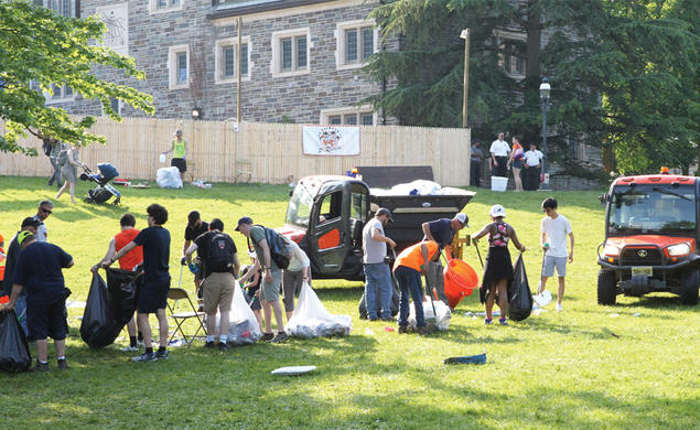 Groups of students and workers cleaning up trash after Reunions